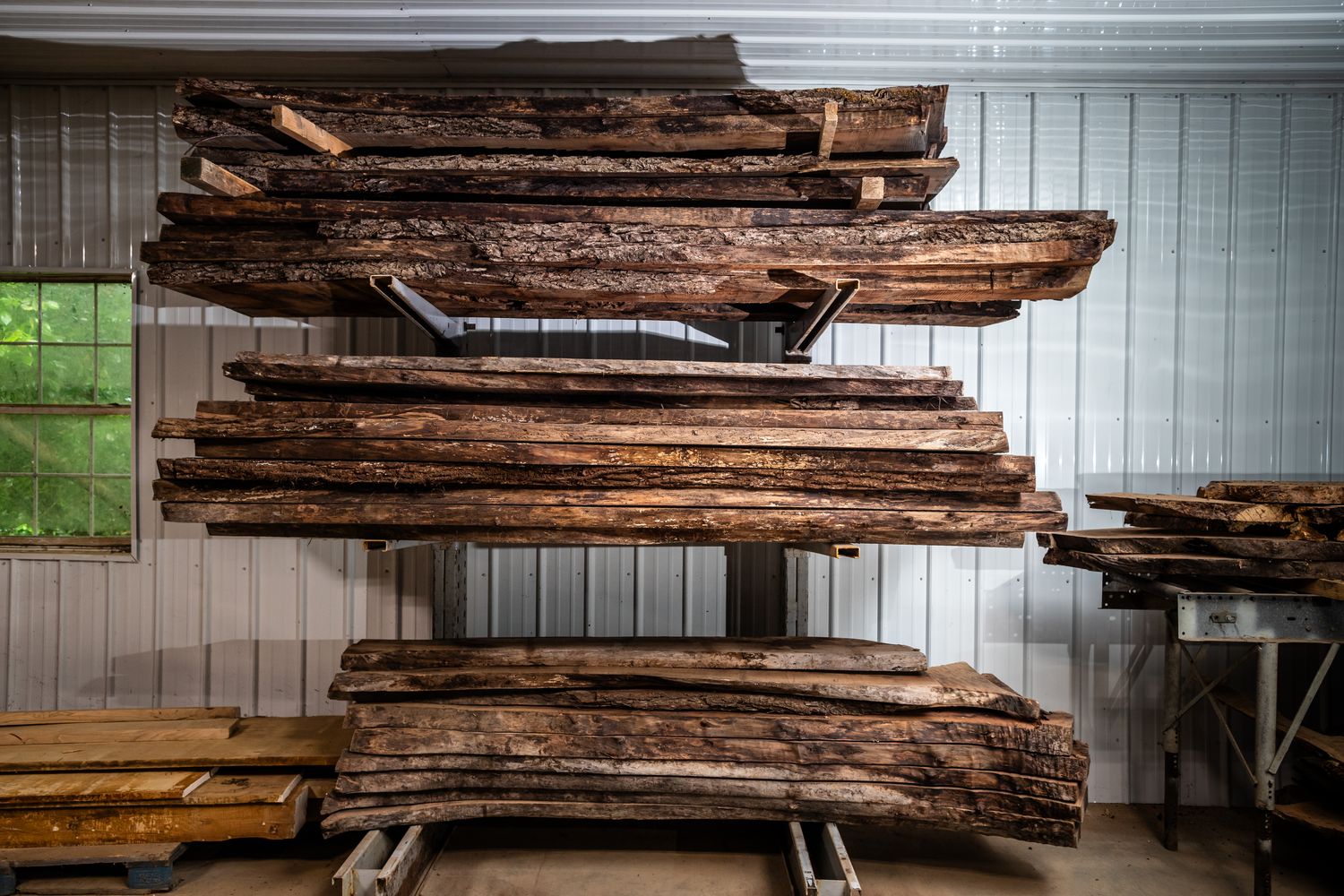 Racks of dried live edge slabs in the warehouse